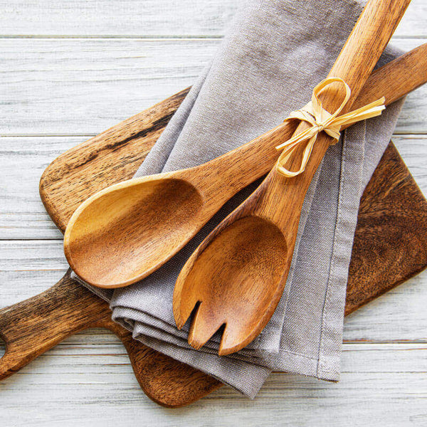 Wooden kitchen utensils on white background. Cutting board, fork