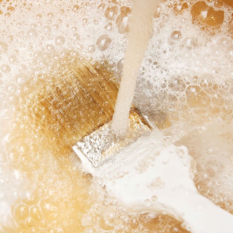 cleaning-a-brush-with-water-and-soap