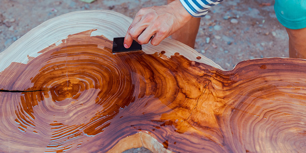 man-oiling-a-beautiful-piece-of-wood-with-wood-oil