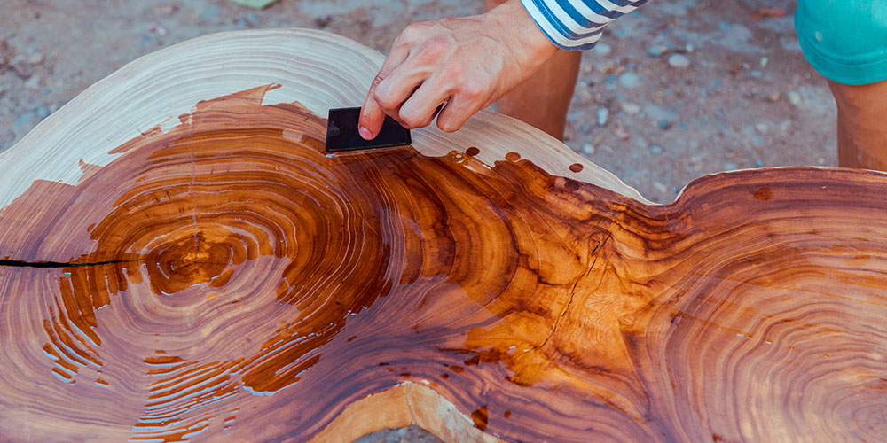 man-oiling-a-beautiful-piece-of-wood-with-wood-oil