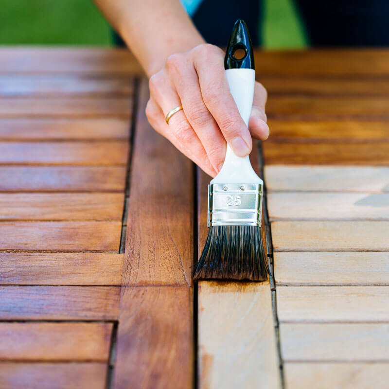 oiling-garden-table-with-brown-wood-oil