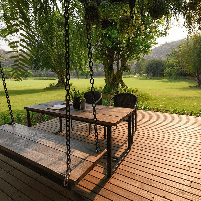 wooden-terrace-with-a-wooden-table-in-a-green-park